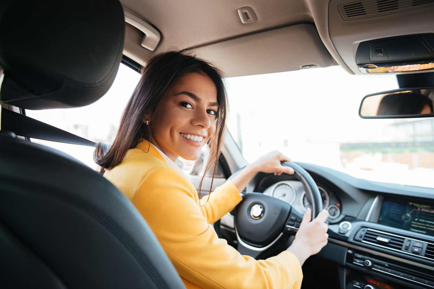 Confident Smiling Woman Driving Car